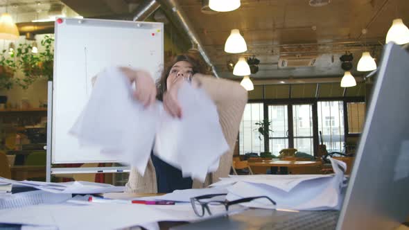 Office Girl Throwing Paper Up in the Air with Happiness