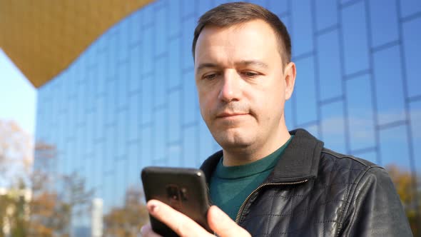 Excited Guy Looks at Phone and Celebrates Big Win Financial Success Achievement Cell Phone