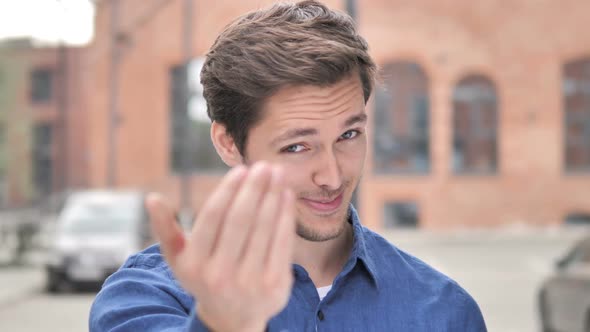 Outdoor Portrait of Young Man Inviting for New Project