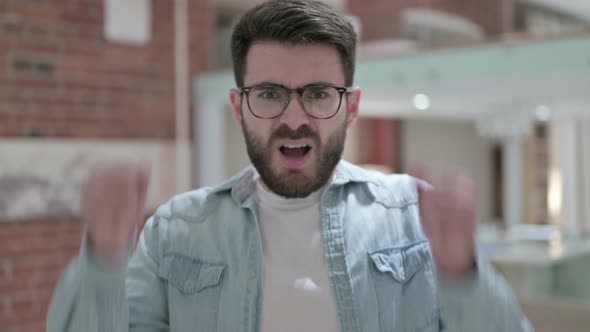 Portrait of Angry Young Male Designer Shouting