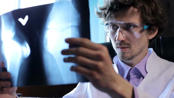 A doctor examines an X-ray of a patient in a clinic.