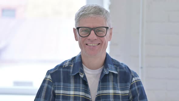 Portrait of Smiling Casual Middle Aged Man Looking at the Camera 