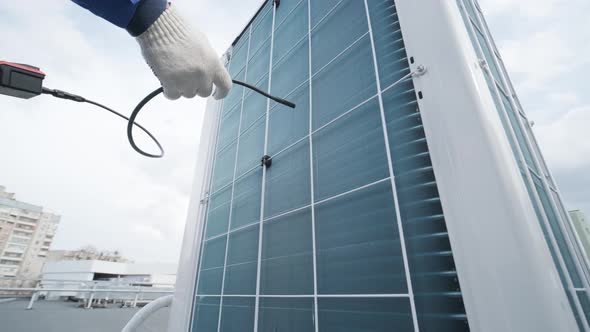 The technician uses a digital camera to check the clogging of the heat exchanger