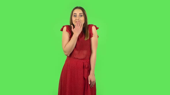 Tender Confused Girl in Red Dress Is Saying Oops and Shrugging. Green Screen