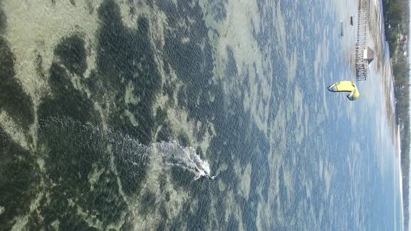 Vertical Video Kitesurfing Near the Shore of Zanzibar Tanzania Aerial View