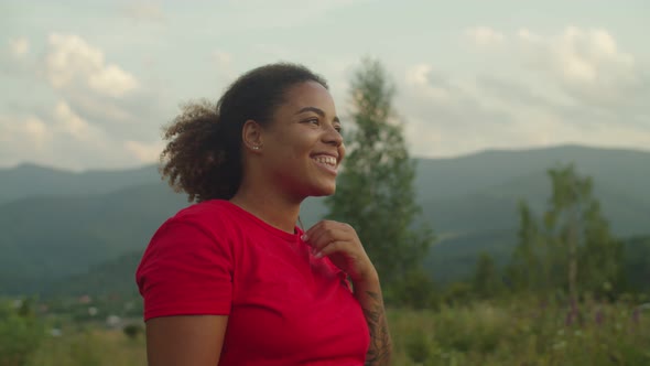 Pretty Relaxed African Woman Hiker Enjoying Recreation and Beautiful Nature in Mountains