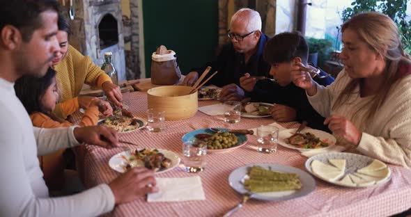 Happy latin family eating dinner at home outdoor