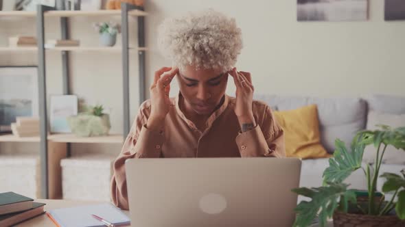 Exhausted African Female Employee Struggle with Blurry Vision or Dizziness