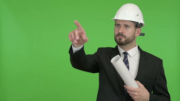 Young Engineer Pointing with Finger and Yes Sign Against Chroma Key