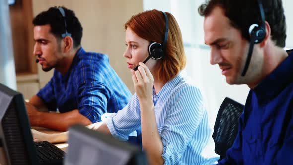 Team of business executives working together at desk