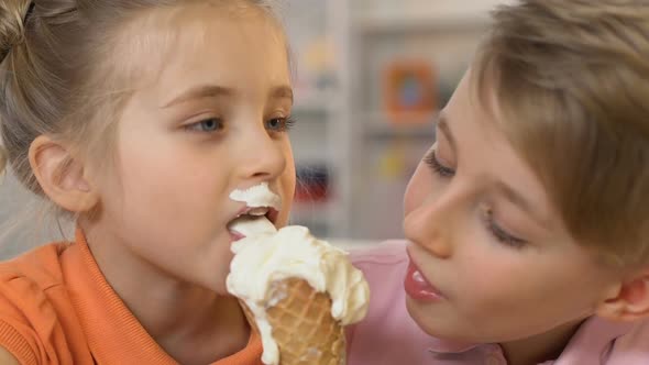 Boy and Girl Greedily Eating Ice-Cream, Favorite Delicious Dessert, Nutrition