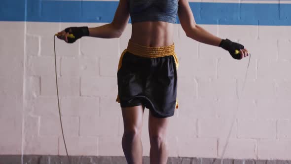 Mixed race woman working out in boxing gym