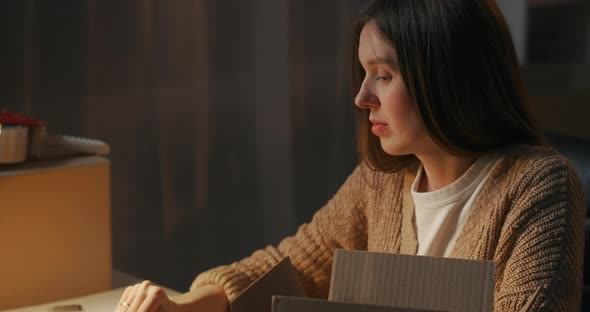 Young Tired Woman Is Finishing Her Work at Home at Evening Turning Off Laptop and Table Lamp Owner