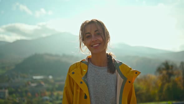 Joyful Freedom Ukrainian Girl in Yellow Jacket Standing Against Mountains and Hills Sun Lights Over