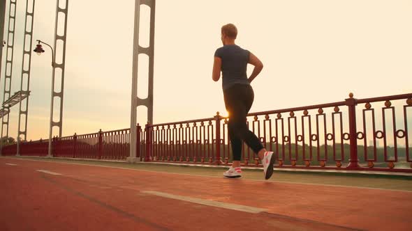 Female Jog in City at Dawn