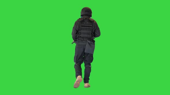 Spec Ops Police Officer SWAT with a Rifle Walking on a Green Screen Chroma Key