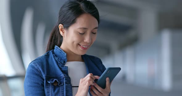 Woman look at mobile phone for searching