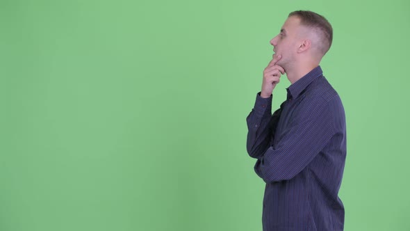 Profile View of Happy Handsome Businessman Thinking