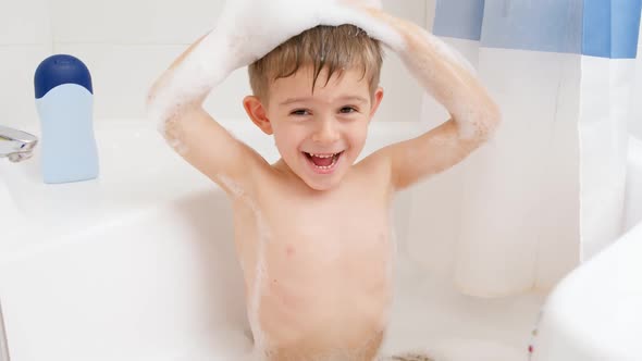 SLow Motion of Happy Funny Little Boy Washing His Head with Shampoo While Taking Bath at Home
