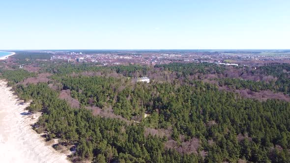 Amber museum and Palanga in horizon near coastline of Baltic sea, aerial view