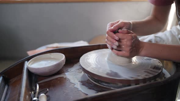 Craftsperson Making Ceramic Jug on Pottery Wheel