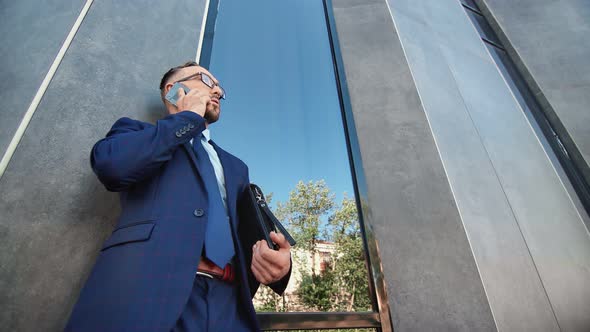 Fashionable Bearded Man in Classy Clothes Discuss Business on Phone