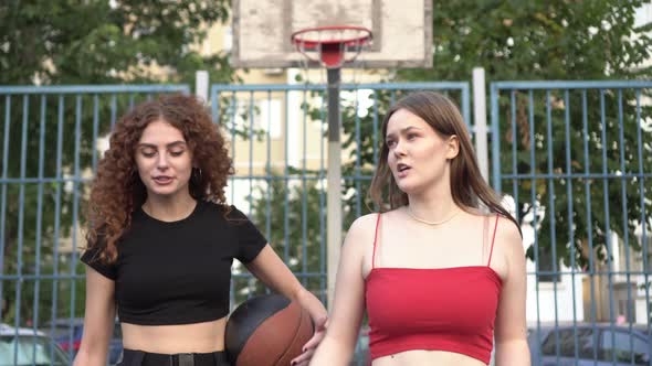 Young Happy Female Friends on the Basketball Court Outdoors