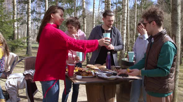 Group Friends Celebrates Birthday in Nature and Drink Together From Paper Cups