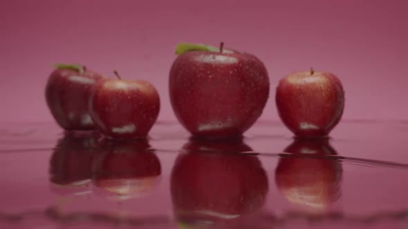 Delicious Red Natural Apples with Water Falling From Above