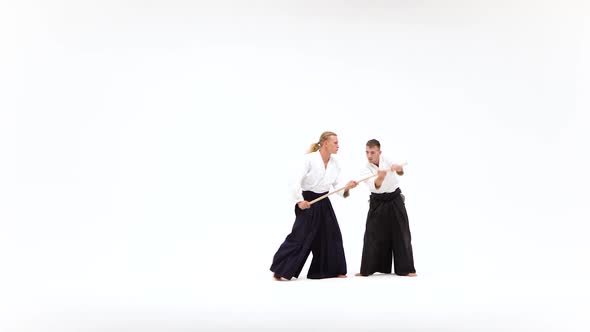 Two Men in Kimono Performing Aikido Using Bokken