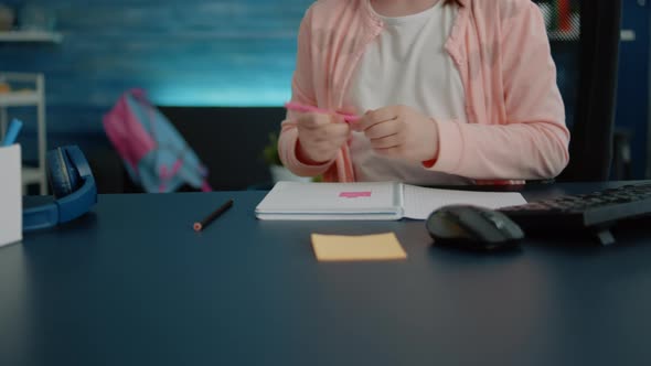 Close Up of Hands of Child Using Pencils for Colorful Notebook