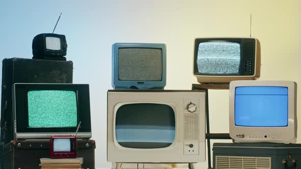 Old Televisions with Grey Interference Screen on Blue and Yellow Background