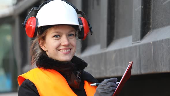 Female technician writing on clipboard