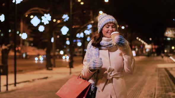 Happy Woman with Coffee and Shopping Bag in Winter