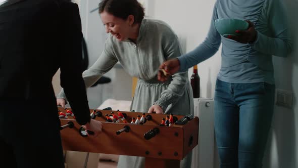 Multi Ethnic Colleagues Playing with Foosball Game Table