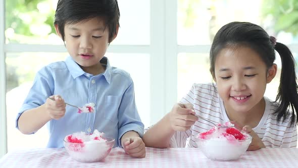 Happy Little Asian Children  Eating Ice Cream At Home