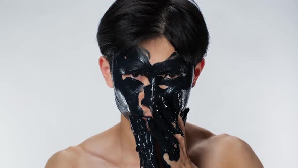 Asian Man Emotion Put Cosmetic Mask Face. Environmental Pollution. Black Oil .