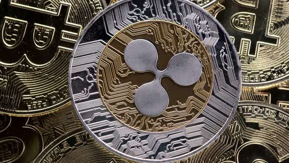 Ripple XRP coin on bitcoins background, cryptocurrency investing concept.