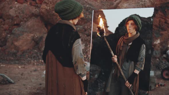 Woman with Torch Looking in Mirror in Dystopian World