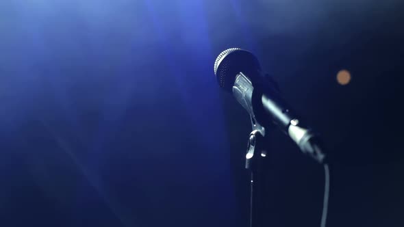 Closeup of Microphone on Stage in the Dark