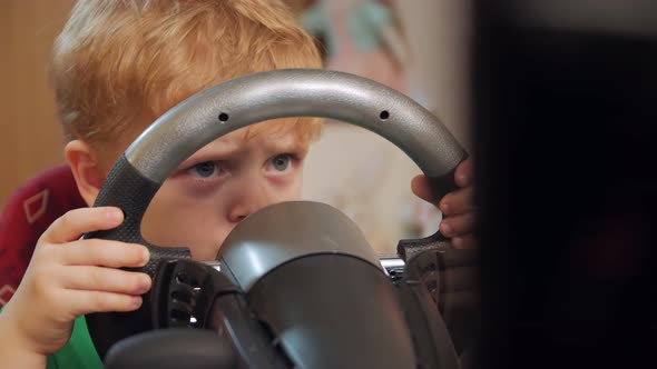 Boy Learning To Drive On The Computer