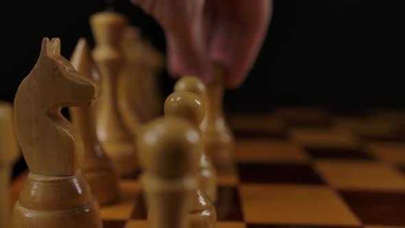 Human's Hand Makes First Move By White Pawn E2 E4 in Chess Game
