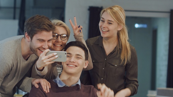 Smiling business people taking selfie in meeting room at