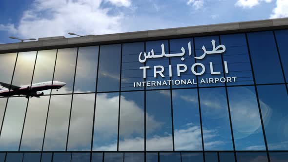 Airplane landing at Tripoli Libya airport mirrored in terminal