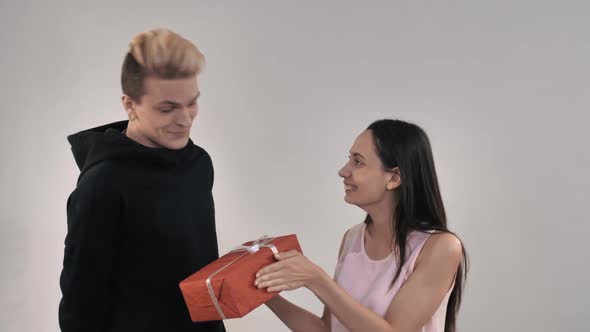 Happy Man and Woman Holding Gift