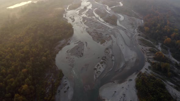 Aerial view of Laba river valley at dawn in autumn, trees, stony coast, Mostovskoy, Caucasus Russia