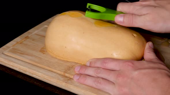 Butternut Pumpkin Skin Being Peeling With Vegetable Peeler. Close Up And Locked Off