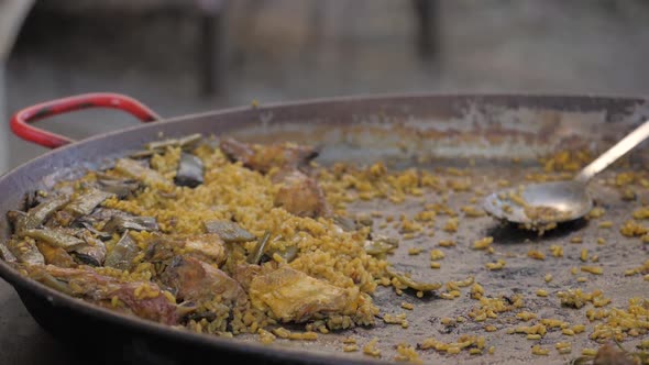 Close Up of a Traditional Paella in Valencia Cooking in a Typical Iron Cast Big Pan on the Street