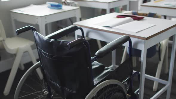 Video of empty wheelchair standing at desk in classroom alt
