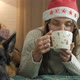 Pretty Woman in a Warm Knitted Sweater Drinks Hot Chocolate and Relaxes While Lying on the Bed with - VideoHive Item for Sale